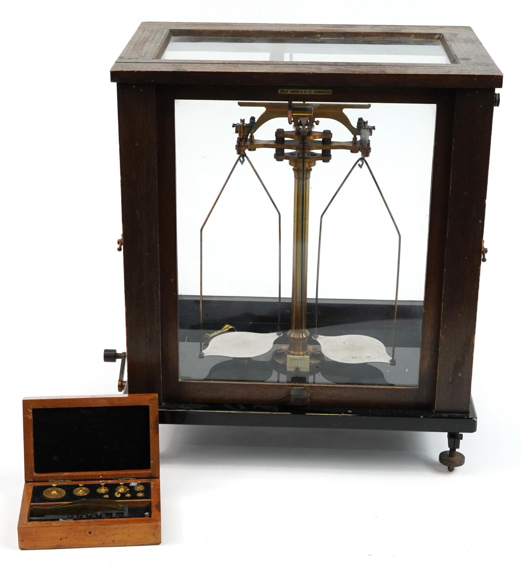 Paul Bunge of Hamburg, set of brass balance scales housed in a glazed oak display case, 43cm H x