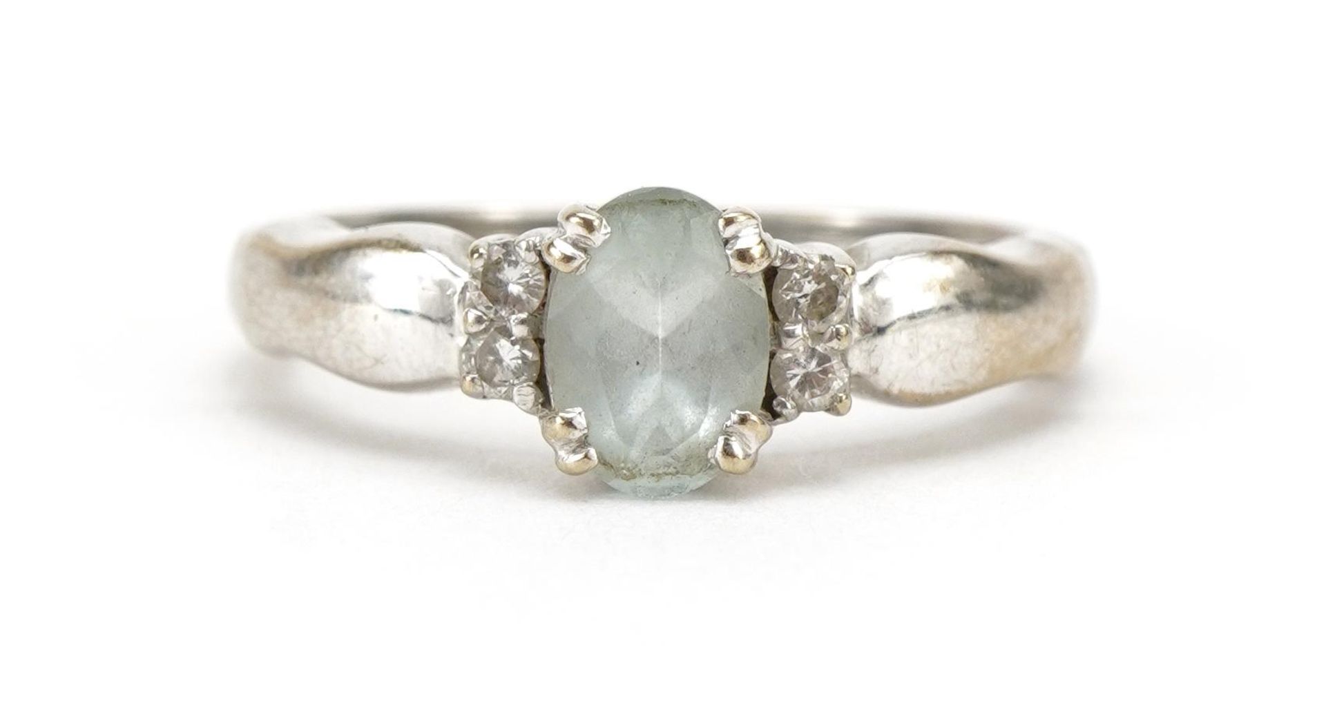 18ct white gold blue stone ring, possibly aquamarine with diamond set shoulders, the band stamped