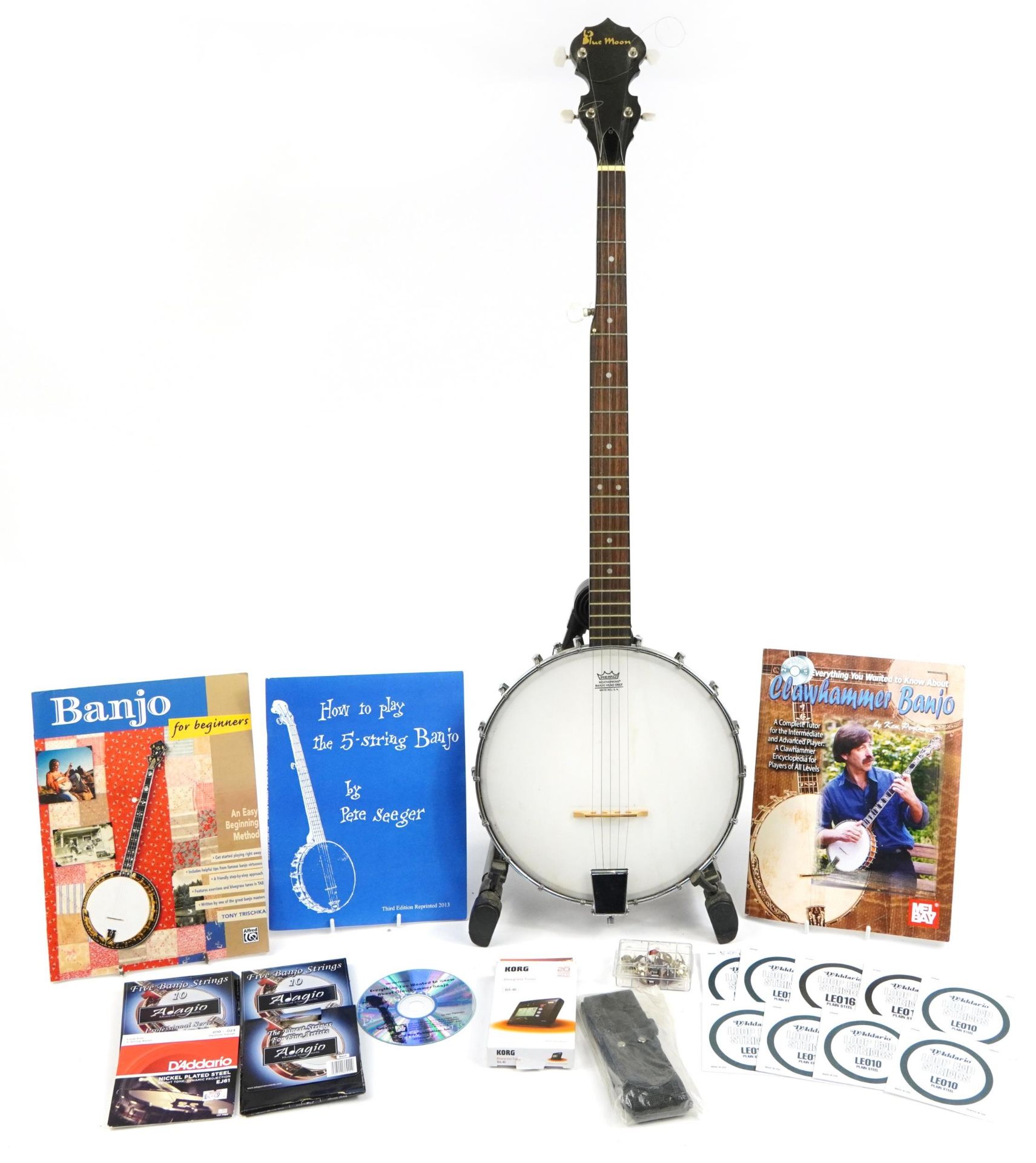 Remo Weatherking rosewood banjo with stand, bare strings and music books