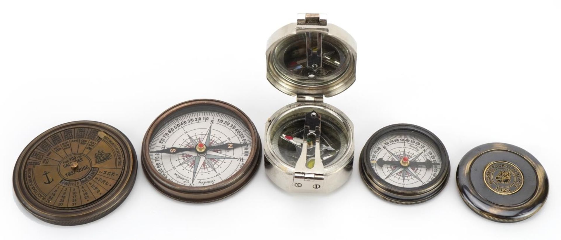 Three naval interest compasses including one with perpetual calendar, the largest 7.8cm in diameter