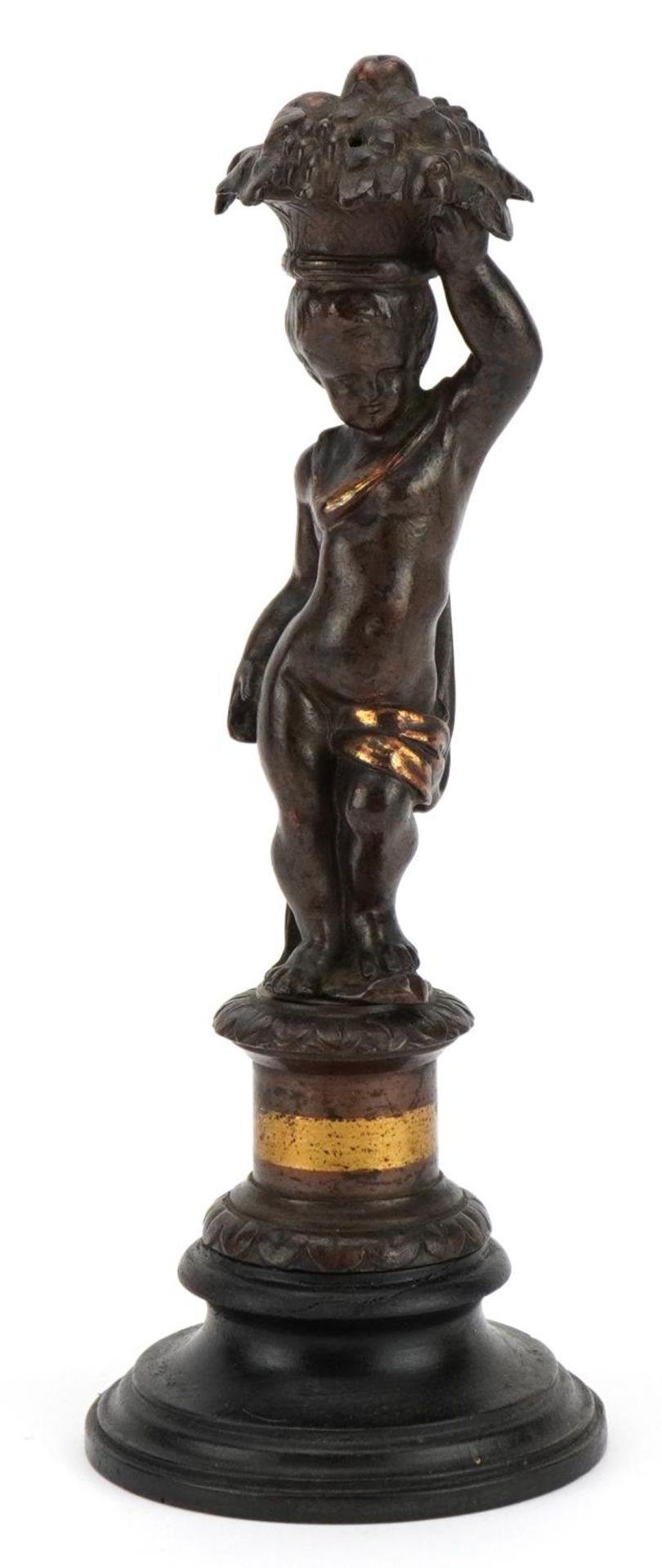 French patinated bronze lustre in the form of a cherub raised on a circular ebonised base, 20cm high