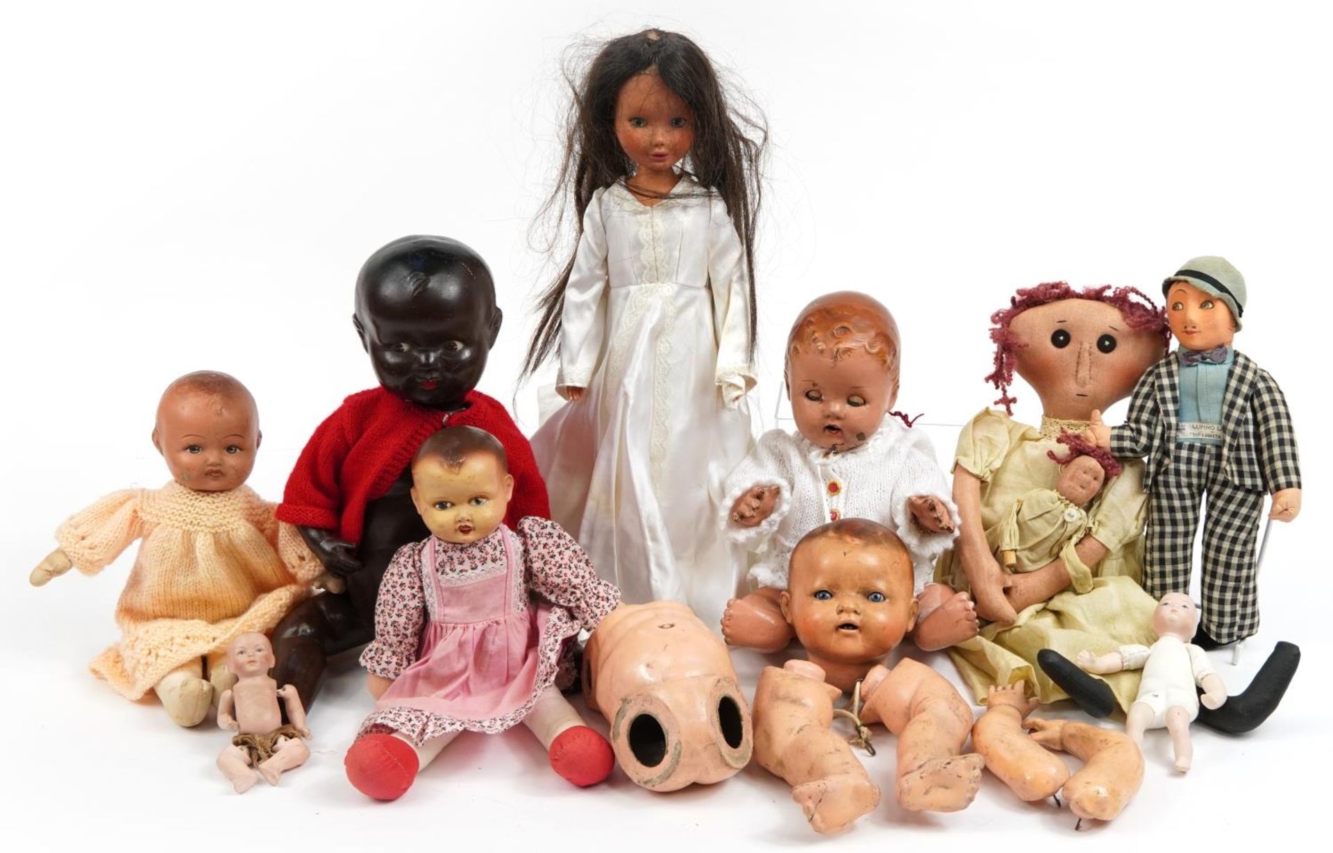 Eight vintage composite and cloth dolls with jointed limbs and two miniature bisque baby dolls,