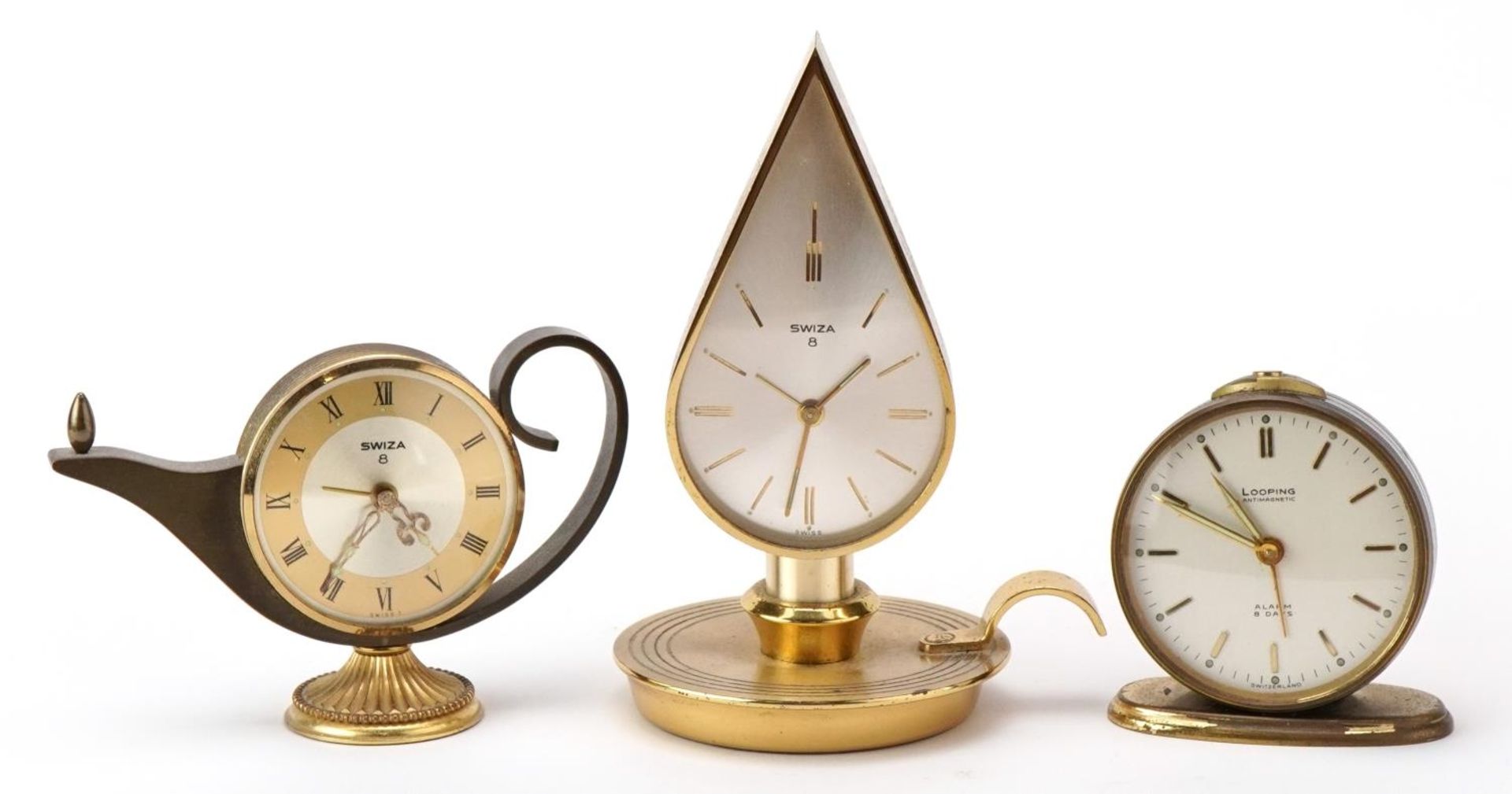 Two vintage Swiza clocks in the form of an oil lamp and chamber stick together with a Looping