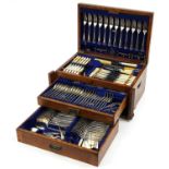 Art Deco oak two drawer canteen with brass inlay and mounts, housing silver plated and stainless