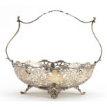 Mappin & Webb, George V silver basket with pierced foliate decoration raised on four feet, London