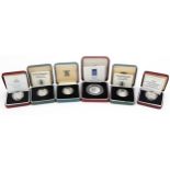 Six silver proof coins with fitted cases including D Day commemorative fifty pence coin and United
