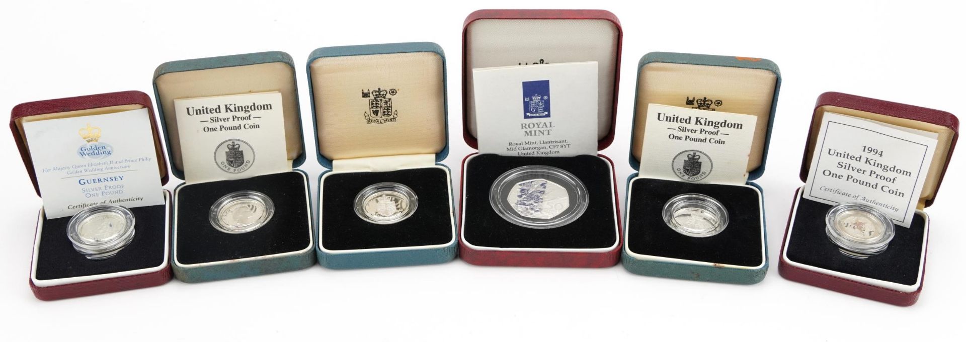 Six silver proof coins with fitted cases including D Day commemorative fifty pence coin and United