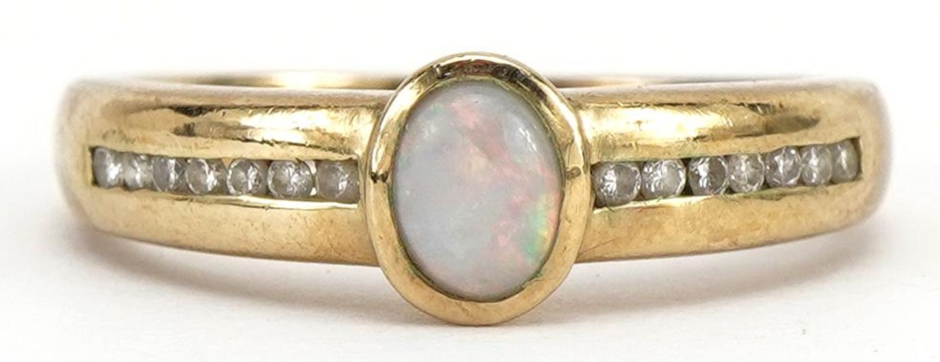 9ct gold cabochon opal ring with diamond set shoulders, the band stamped 0.09ct, size L, 2.5g