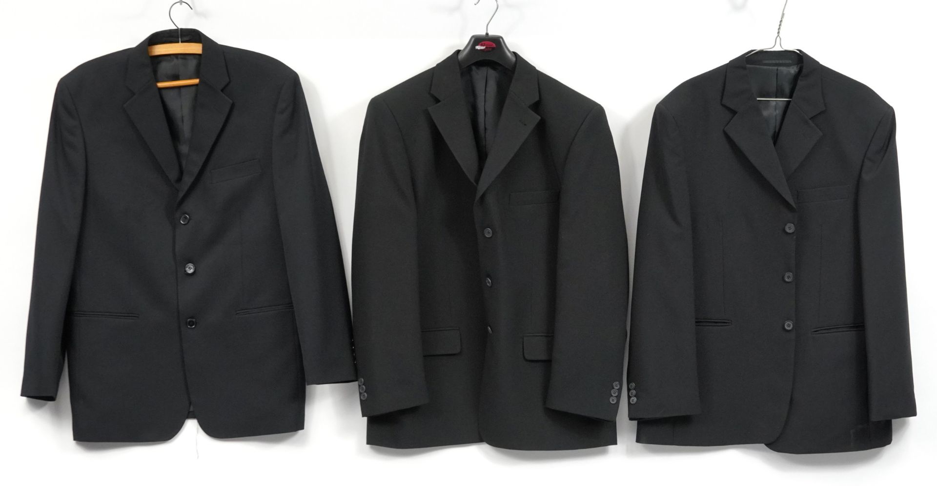 Three large black gentlemans suit jackets