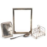 Silver objects comprising four slice toast rack, cigarette case, rectangular photo frame and a