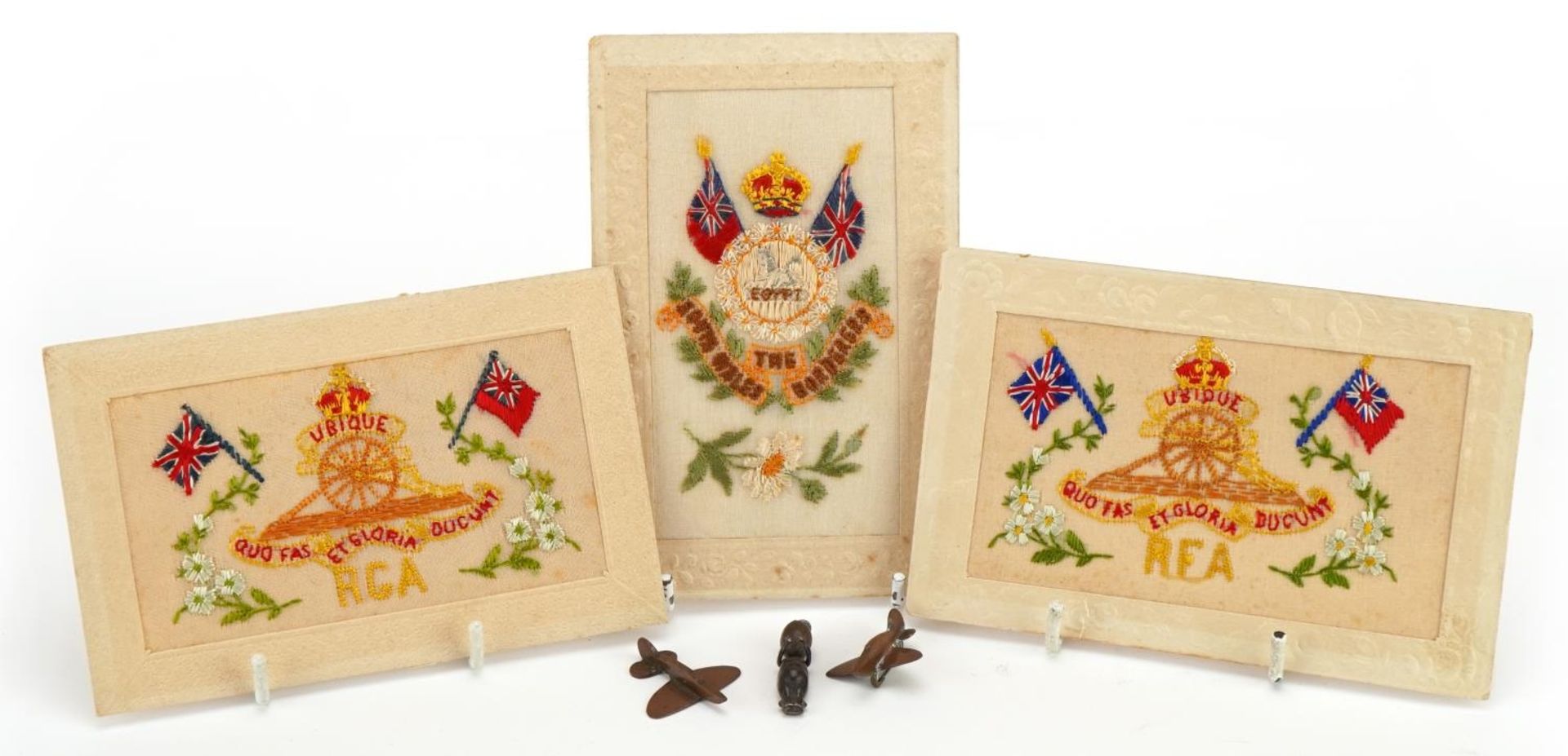 Militaria including a Fumsup pendant, trench art aeroplane brooches and silk greetings cards