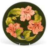 Moorcroft pottery plate hand painted with flowers, signed to the base, 31cm in diameter