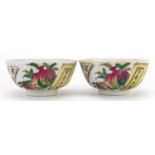 Pair of Chinese porcelain bowls hand painted with peaches and calligraphy, six figure iron red