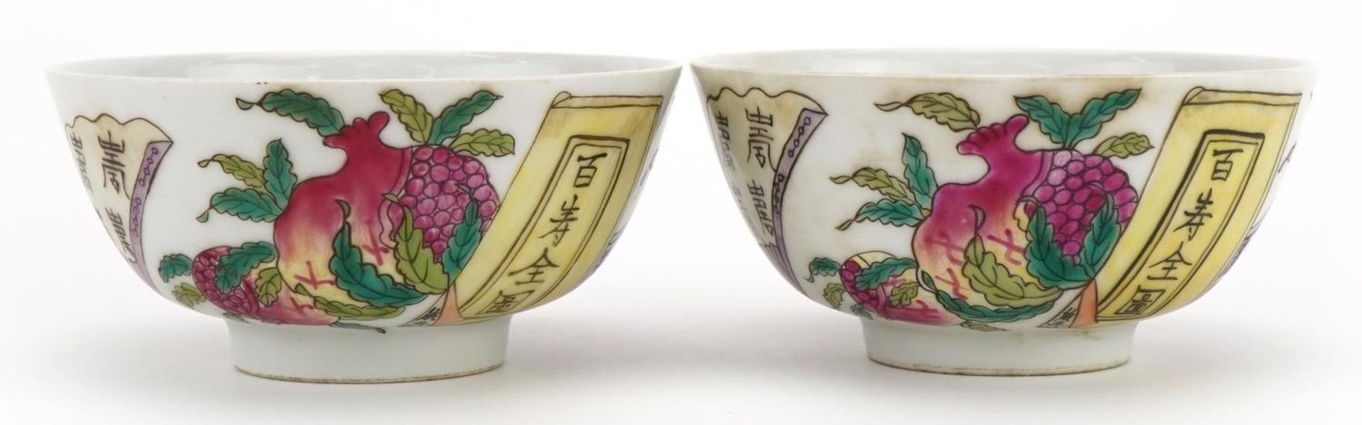 Pair of Chinese porcelain bowls hand painted with peaches and calligraphy, six figure iron red