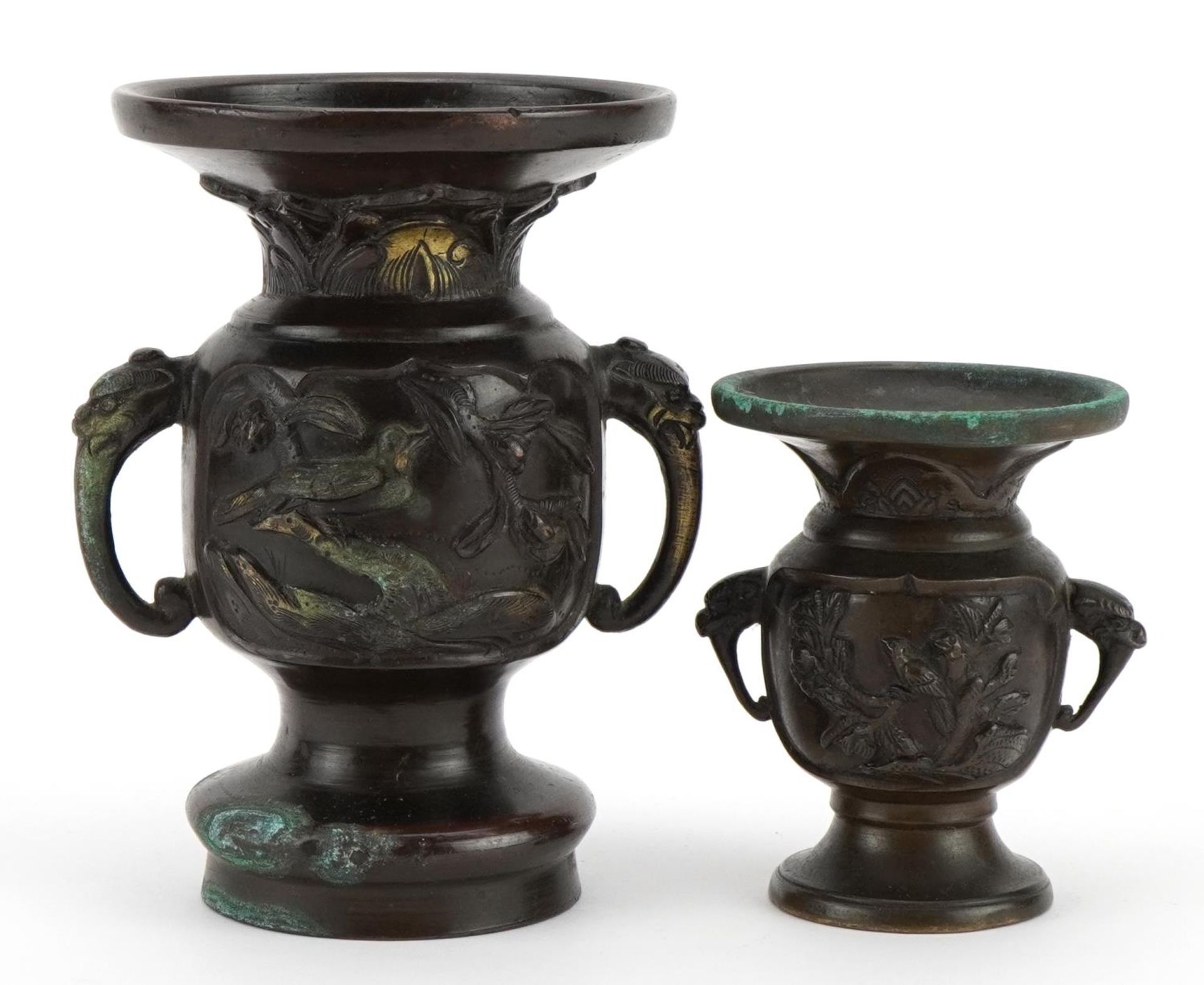 Two Japanese bronze vases, each with twin elephant head handles and decorated in relief with birds
