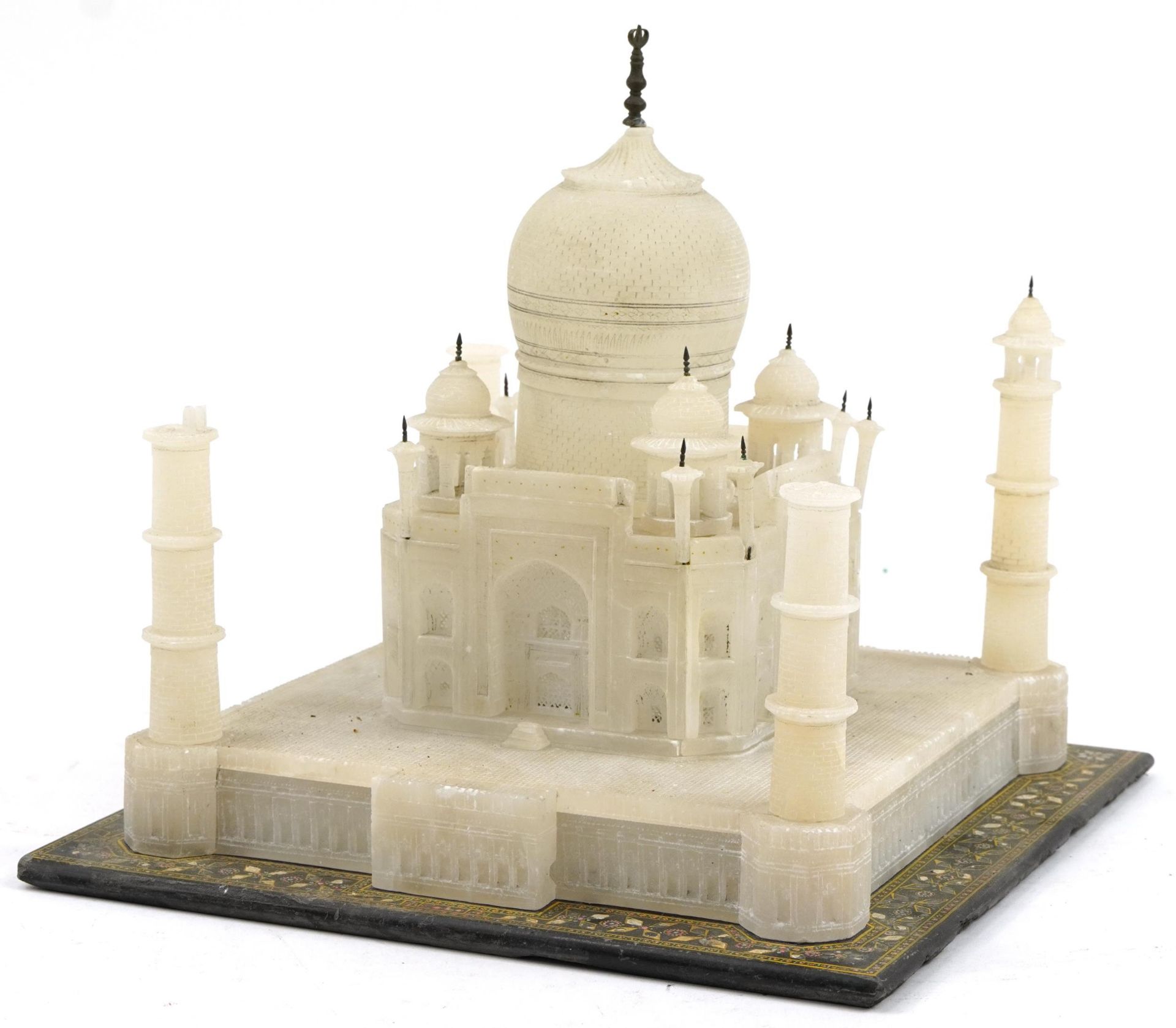 Indian alabaster carving of the Taj Mahal raised on a black slate base, the base 31cm x 31cm