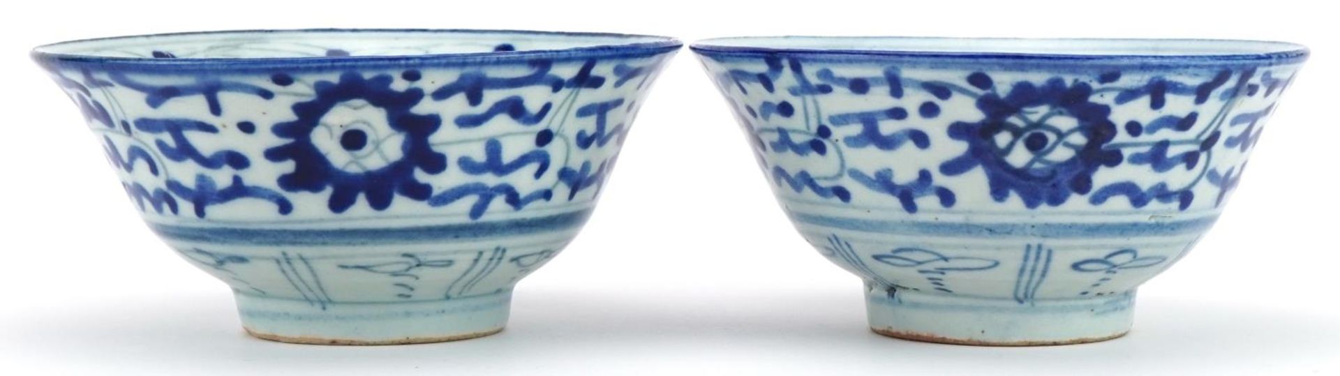 Pair of Chinese blue and white porcelain bowls hand painted with flowers, character marks to the