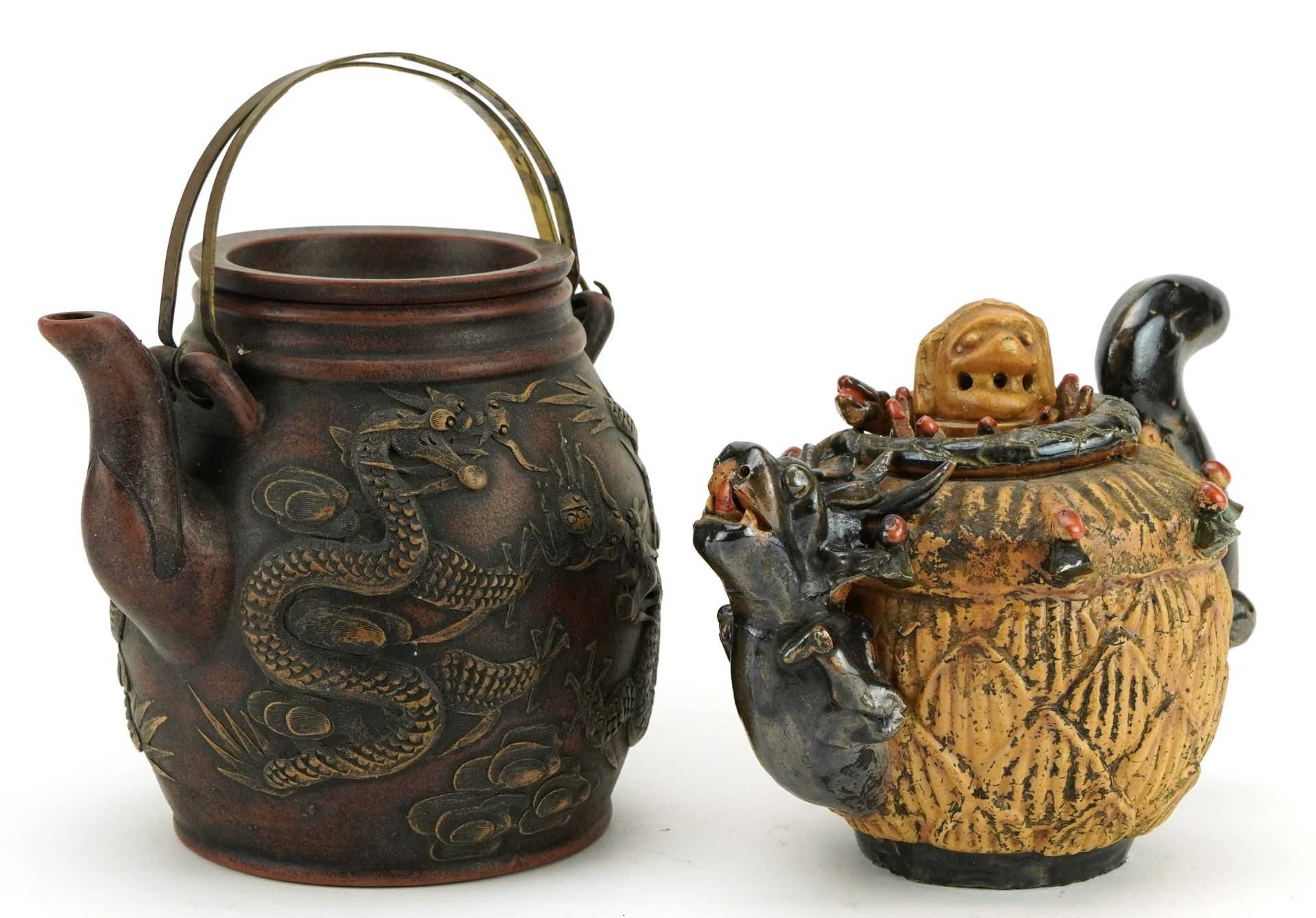 Chinese Yixing terracotta teapot decorated with dragons and one other, the largest 15cm high