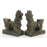 Pair of Chinese patinated bronze guardian dogs, 9.4cm in length