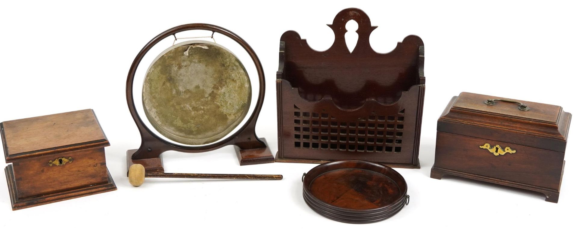 Woodenware including a Georgian mahogany tea caddy, table dinner gong, circular coaster with ring