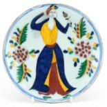 Turkish Ottoman Iznik pottery dish hand painted with a figure in traditional dress and flowers, 15cm