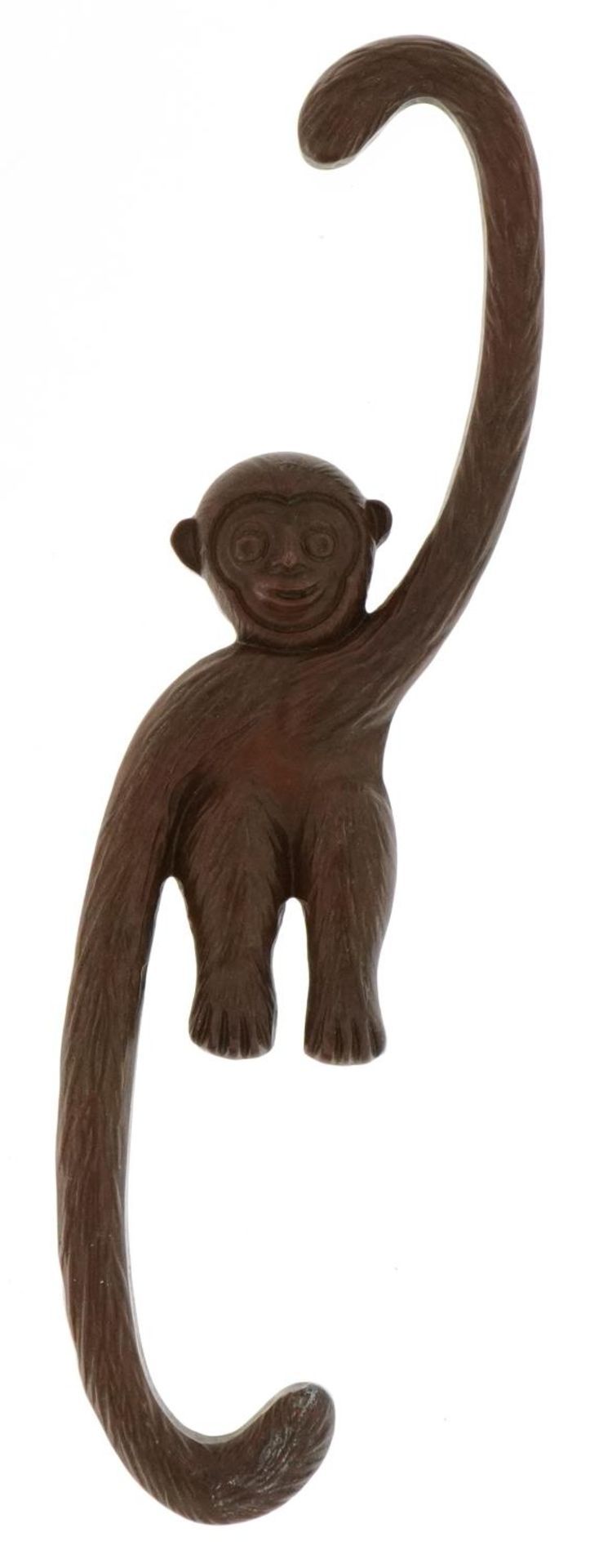 Japanese patinated bronze monkey with impressed mark, 14.5cm in length