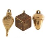 Three 9ct gold charms comprising dice, acorn and bellows, the largest 2.3cm high, 2.6g