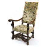 Antique carved oak framed throne chair with floral upholstered back and seat, 119cm high