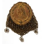Victorian brass miser's purse with a bust of Queen Victorian and sovereign holder, 9cm high