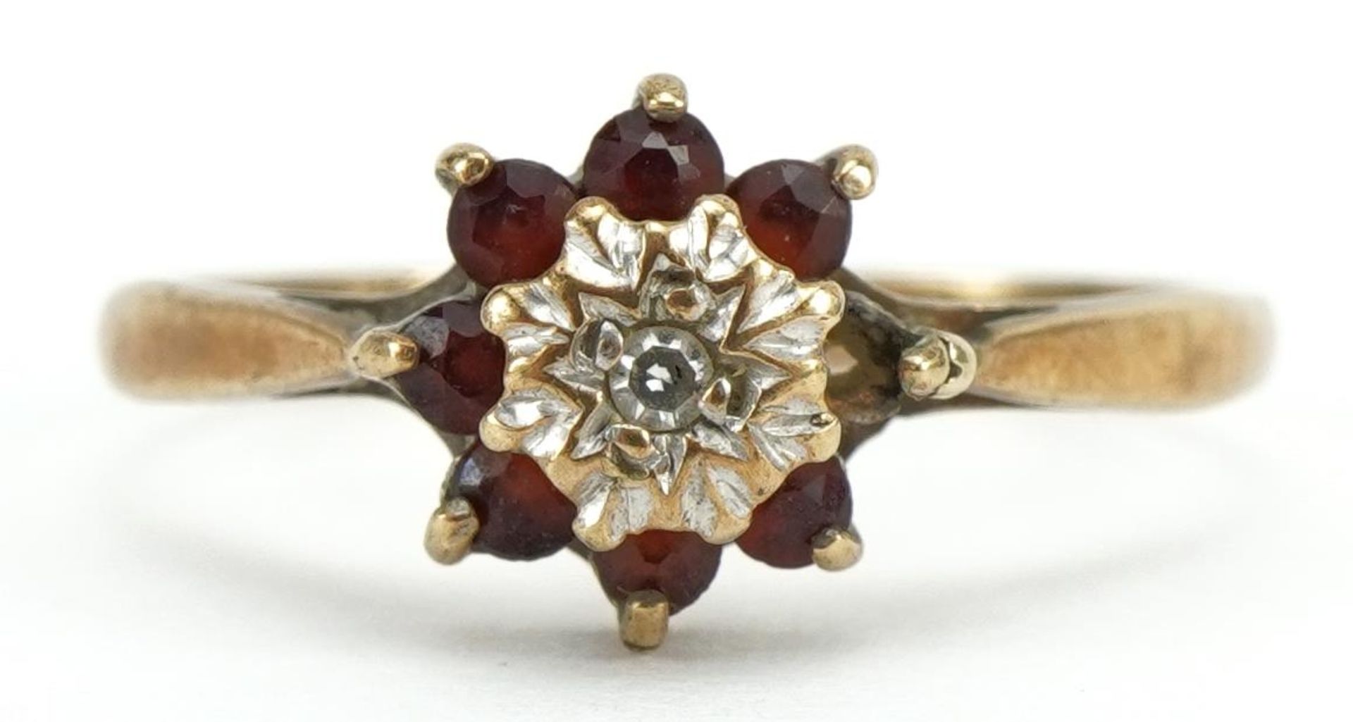 9ct gold garnet and diamond flower head ring, Birmingham 1975, size L, 1.3g