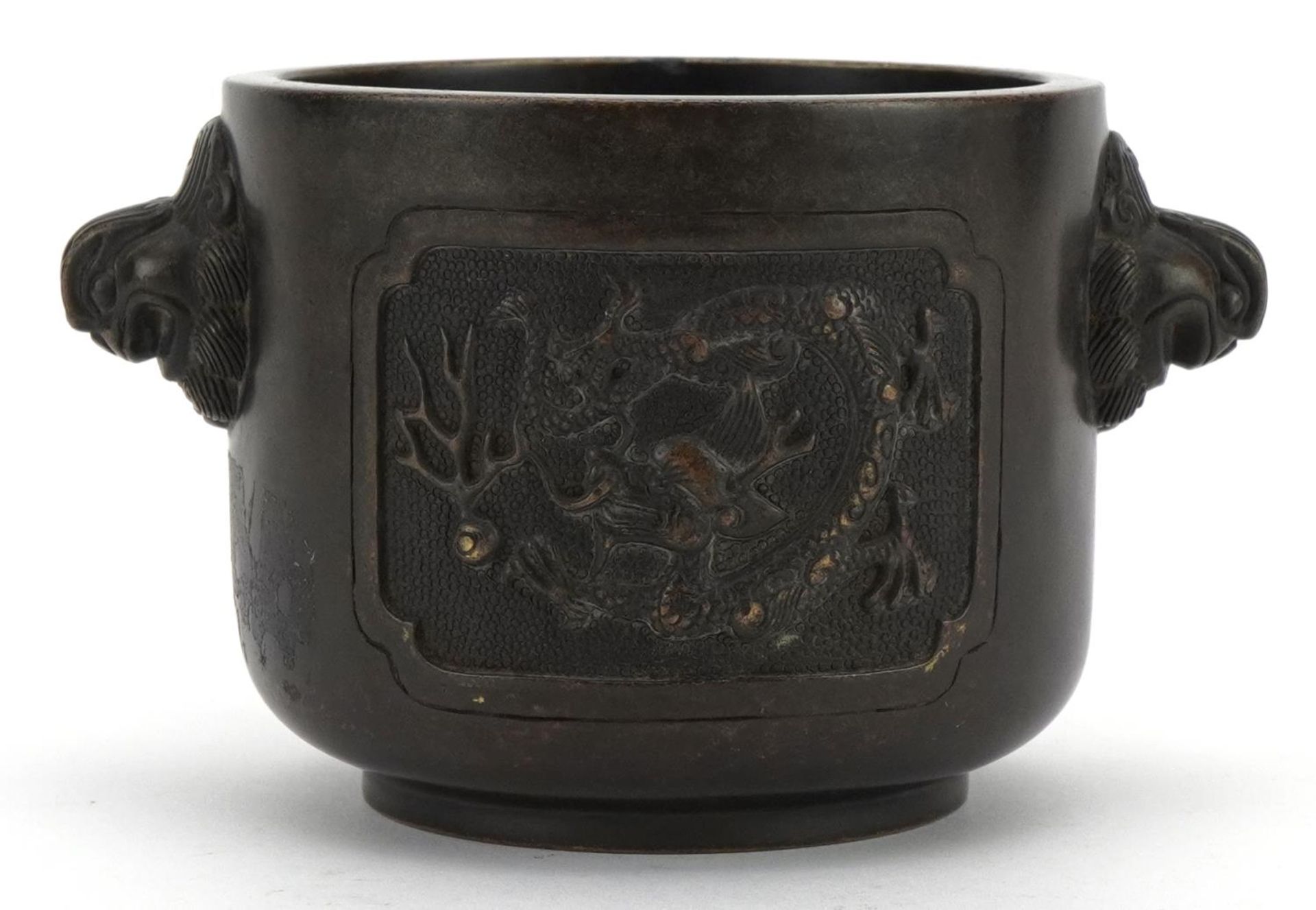 Chinese patinated bronze censer with twin handles cast with panels of dragons chasing a flaming