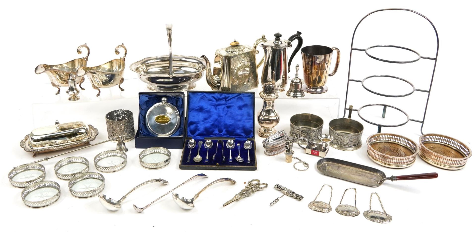 Silver plated items including swing handled basket, coasters, sugar sifter and pair of sauceboats