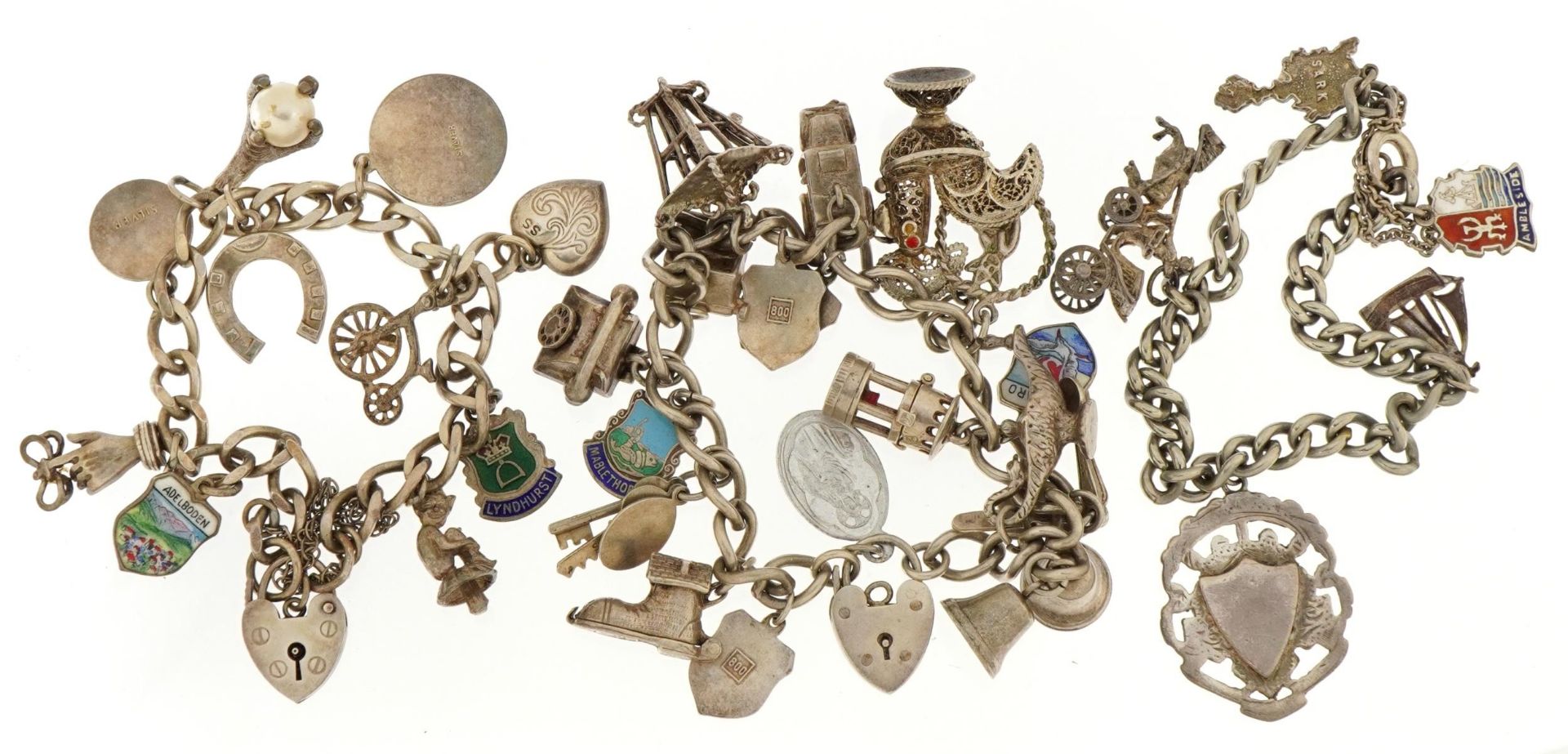 Three silver charm bracelets with a selection of mostly silver charms including chicken with red