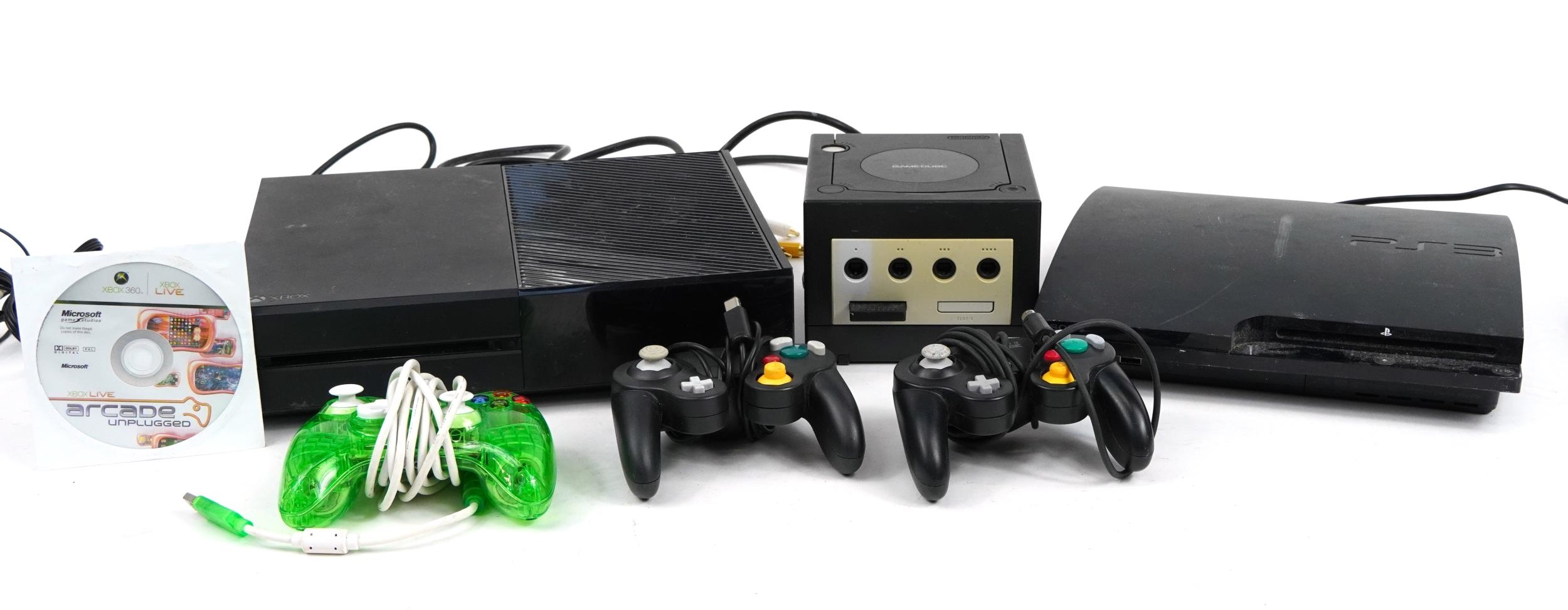 Three games consoles with controllers comprising Play Station 3, Nintendo Gamecube and Xbox