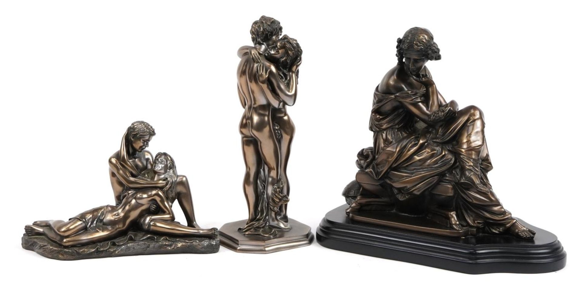 Two bronzed figure groups of erotic couples and a female seated on a stool, the largest 31cm in