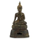 South East Asian partially gilt patinated bronze figure of seated Buddha, 22cm high