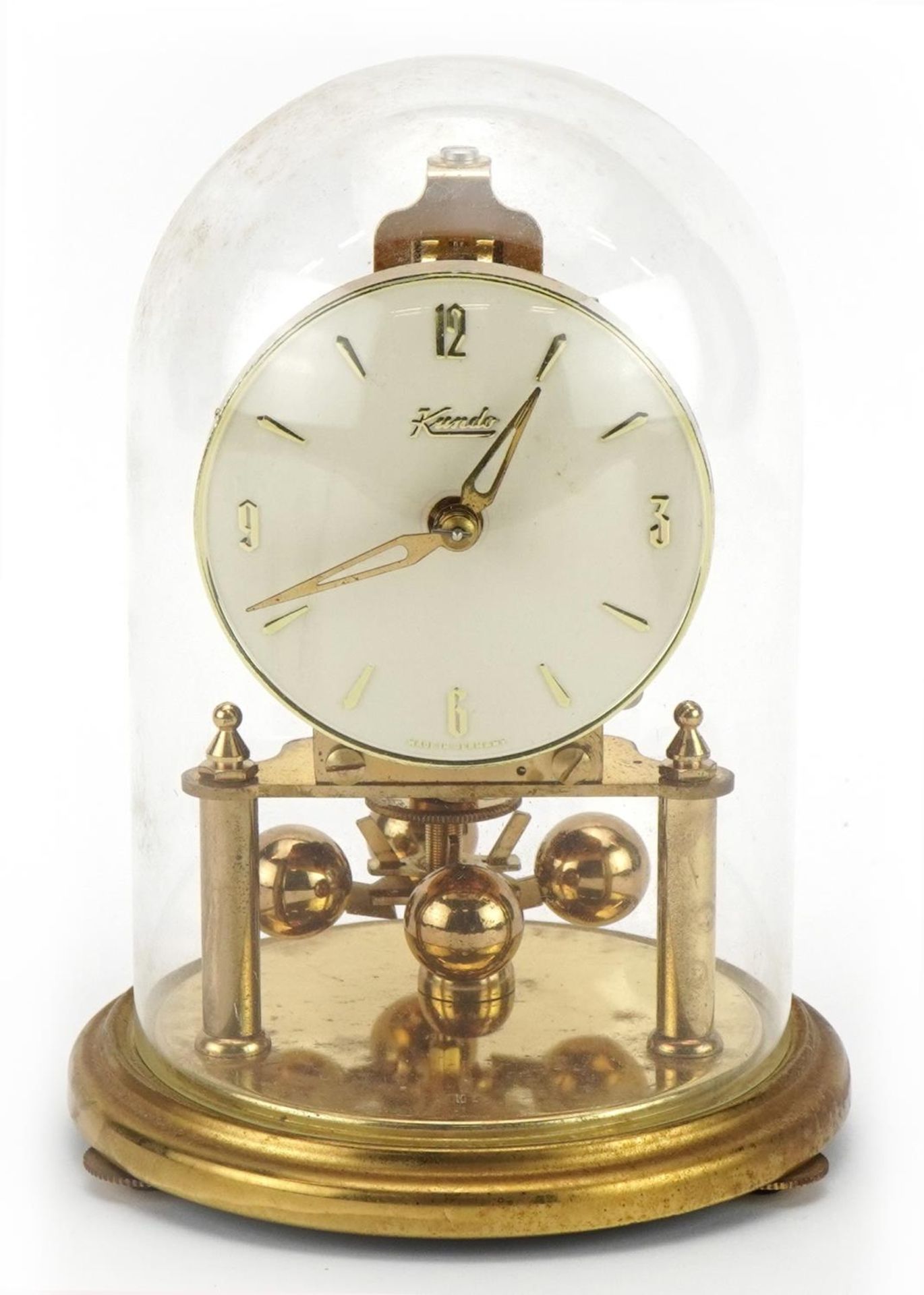 Kendo brass anniversary clock under a glass dome, 18cm high