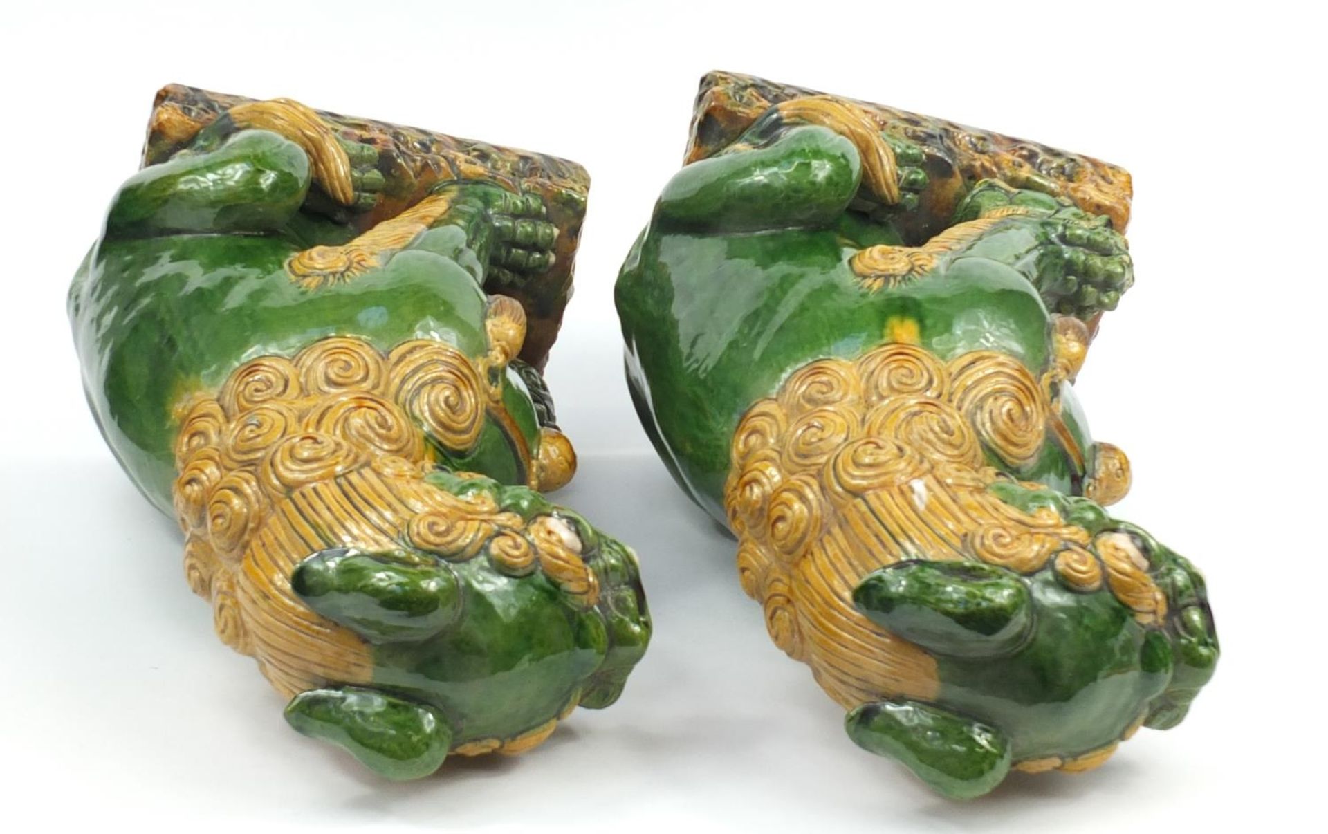 Large pair of Chinese floor standing pottery seated lions having a sancai type glaze, each 59cm high - Image 6 of 7