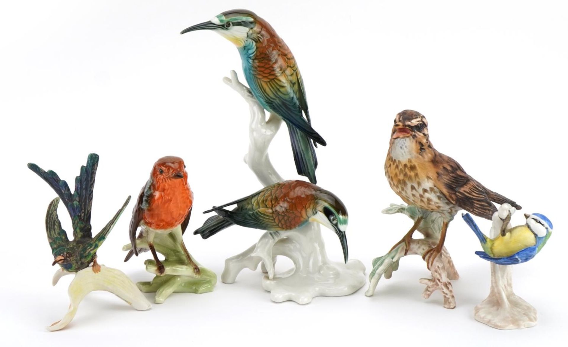 Five collectable porcelain bird groups comprising Karl Enz and Goebel, the largest 23cm high