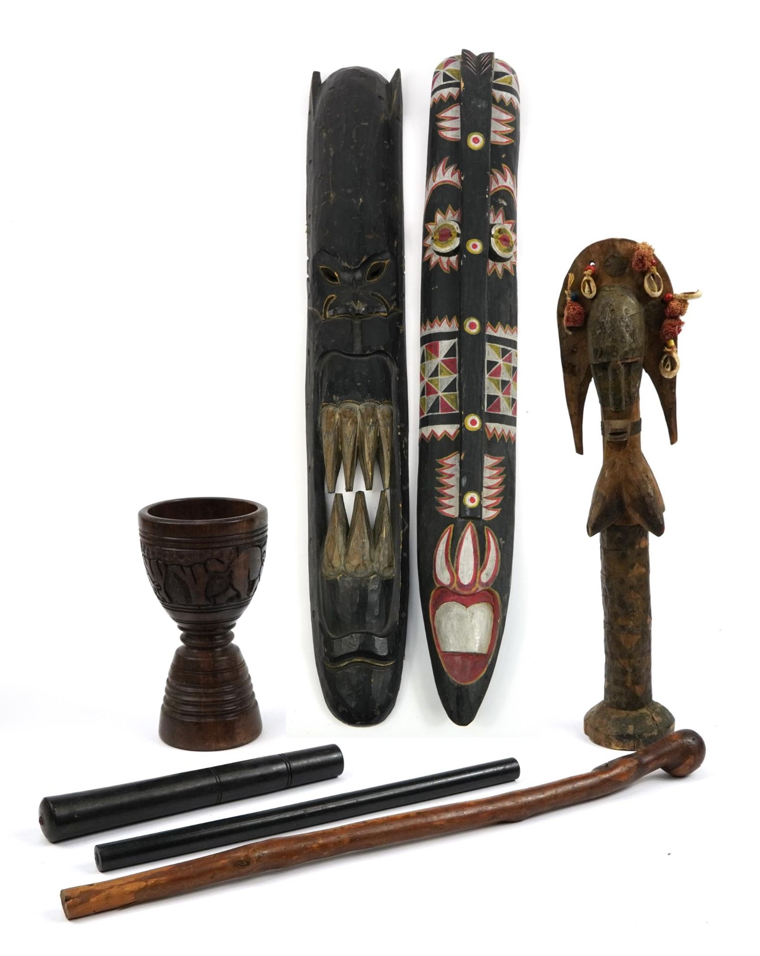 African and tribal carved wood items including two large hand painted wall masks and ebony