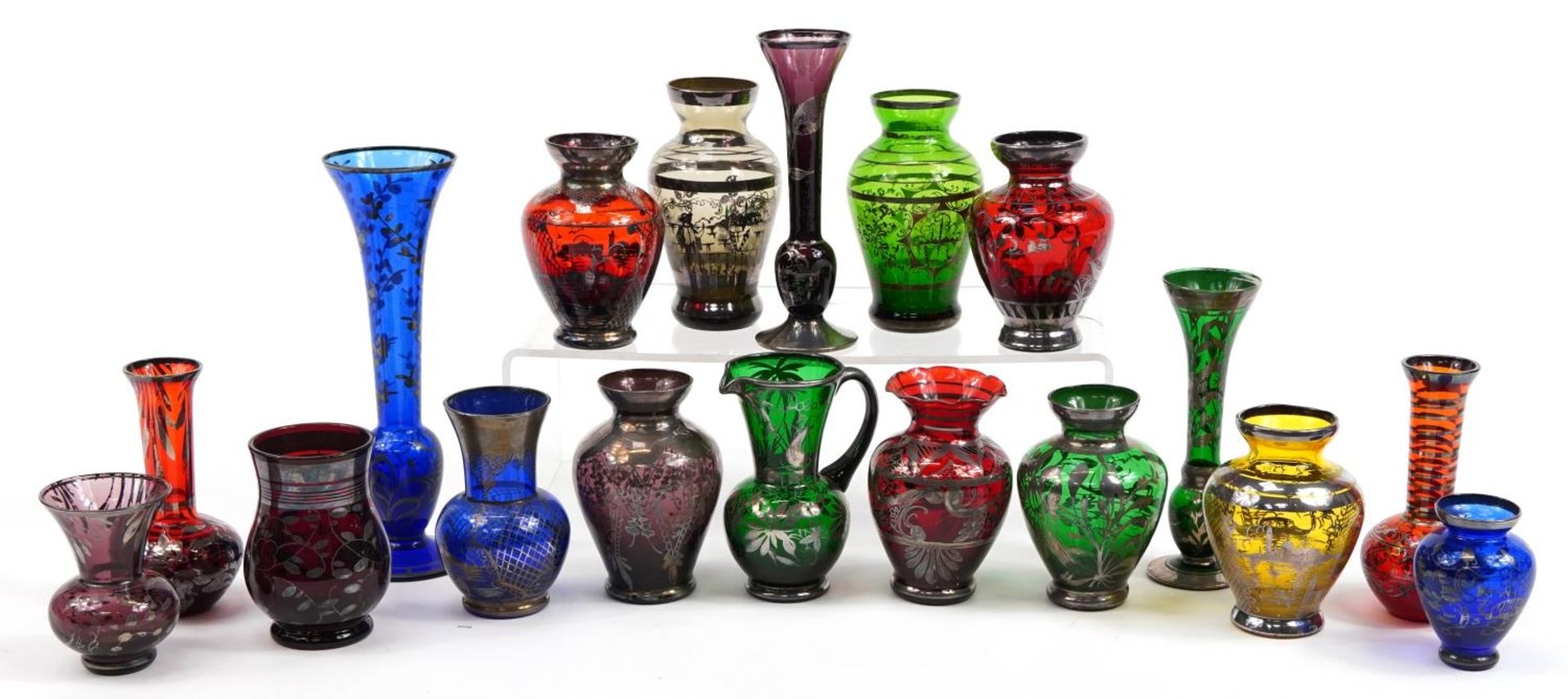 Collection of silver overlaid colourful glass vases and jugs, the largest 20cm high