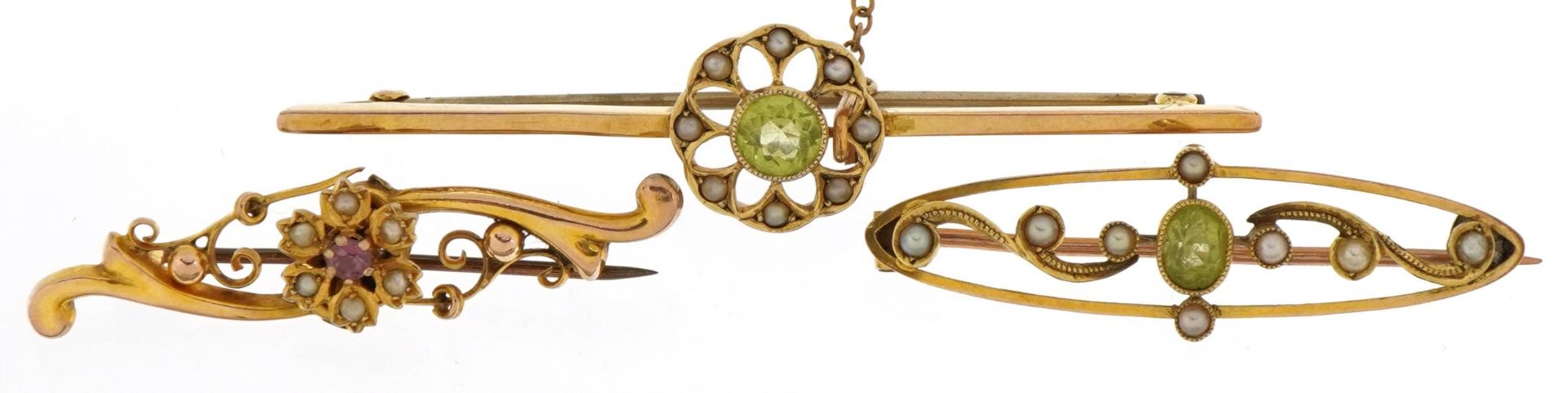 Three antique and later 9ct gold bar brooches with safety chains set with seed pearls, peridots