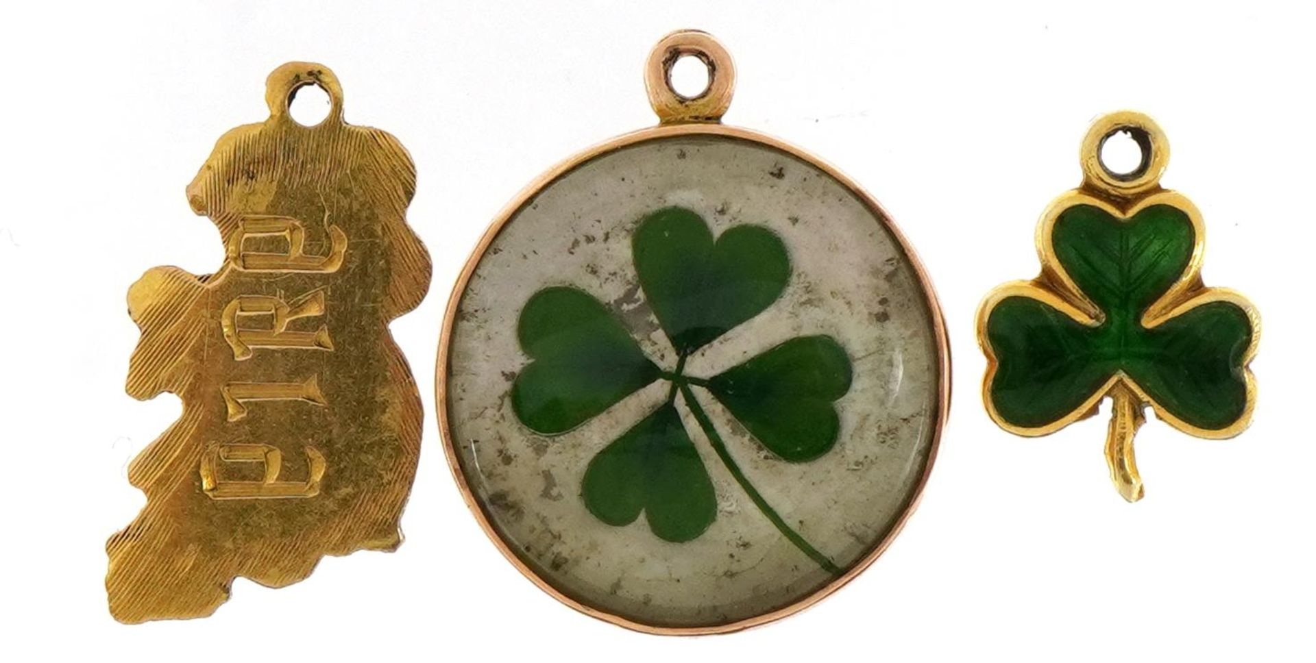 Three antique and later Irish charms comprising 9ct gold Eire, 9ct gold and enamel three leaf clover