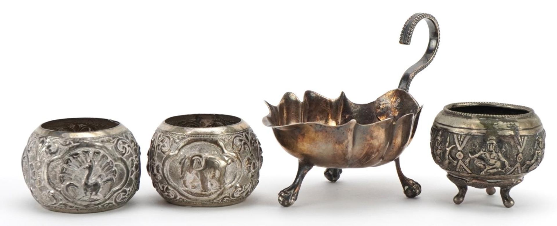 WITHDRAWN Antique silver three footed sauce boat, Indian white metal open salt and two white metal