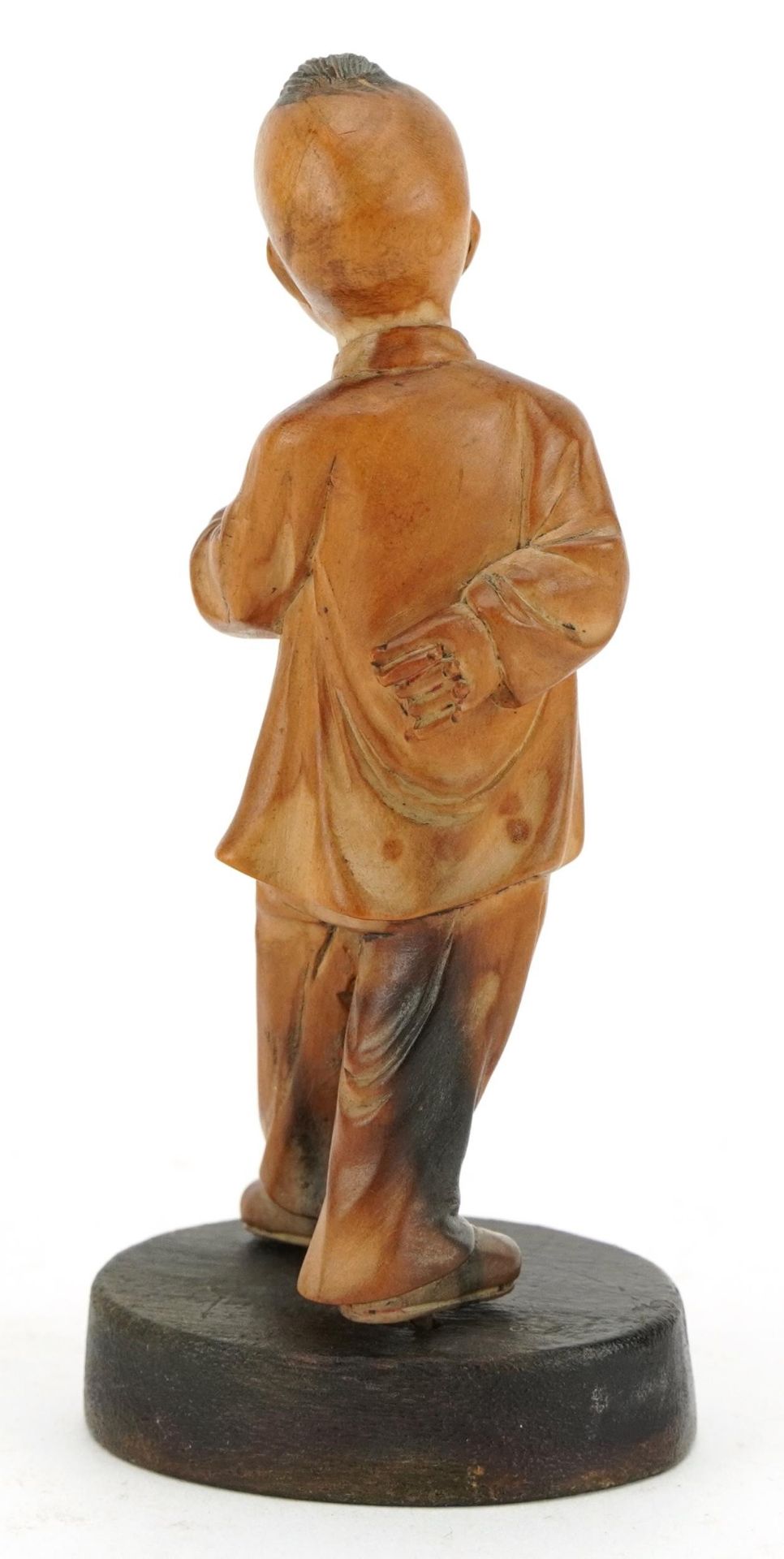 Chinese boxwood carving of a young boy holding a fruit, raised on an oval base, 11cm high - Image 2 of 3