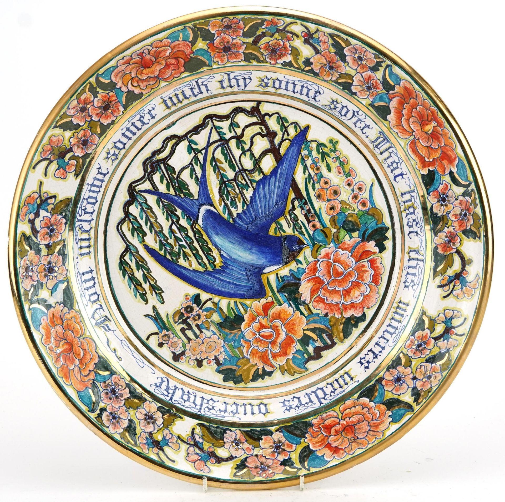 Italian Maiolica lustre charger hand painted with a swallow amongst flowers, with calligraphy,