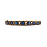 Victorian 15ct gold hinged bangle set with nine graduated blue stones, 6.5cm wide, 14.5g