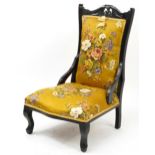 Edwardian mahogany nursing chair with gold floral upholstery, 93cm high