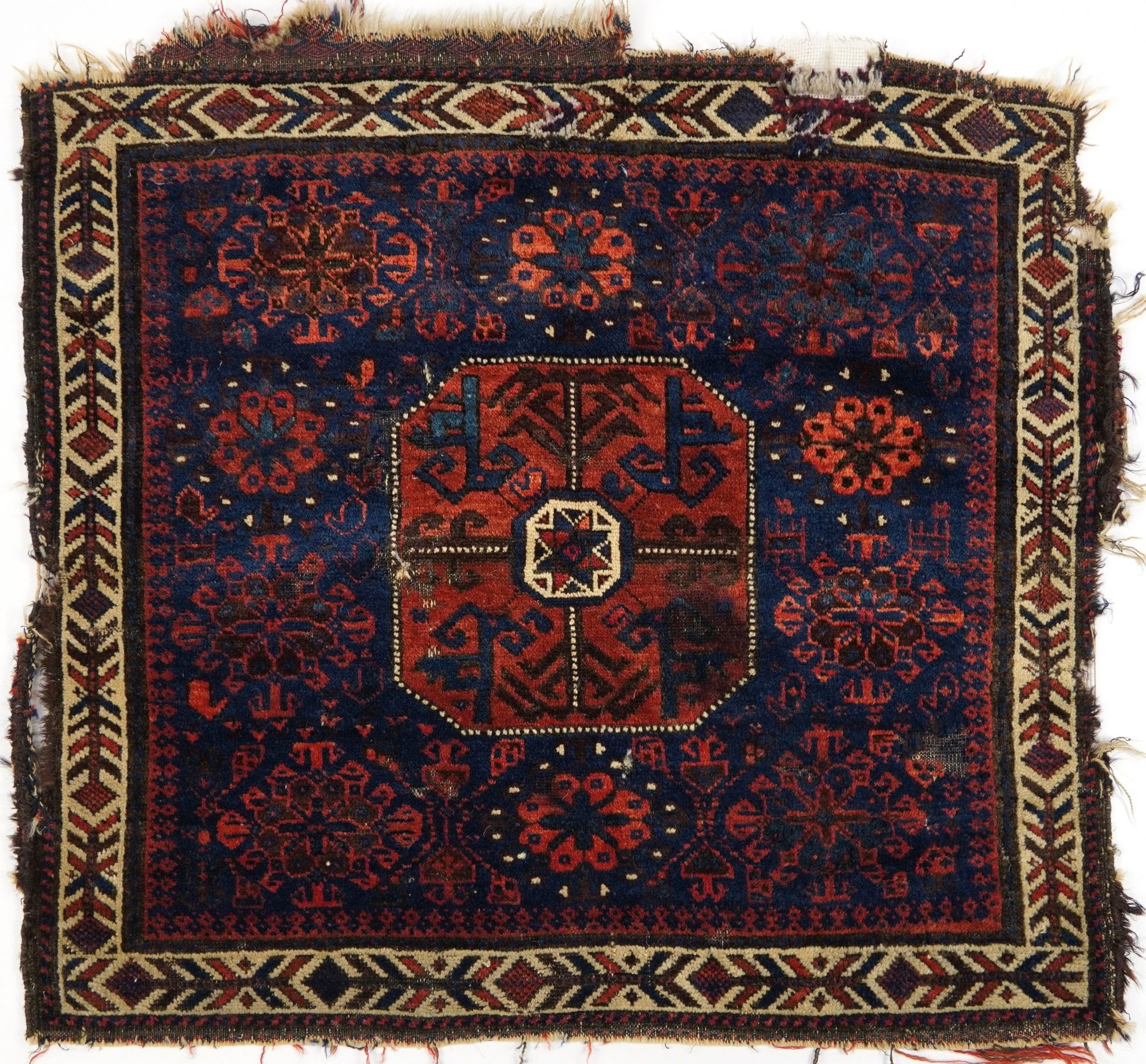 Afghan red and blue ground Belutch rug with all over geometric design, 86cm x 76cm