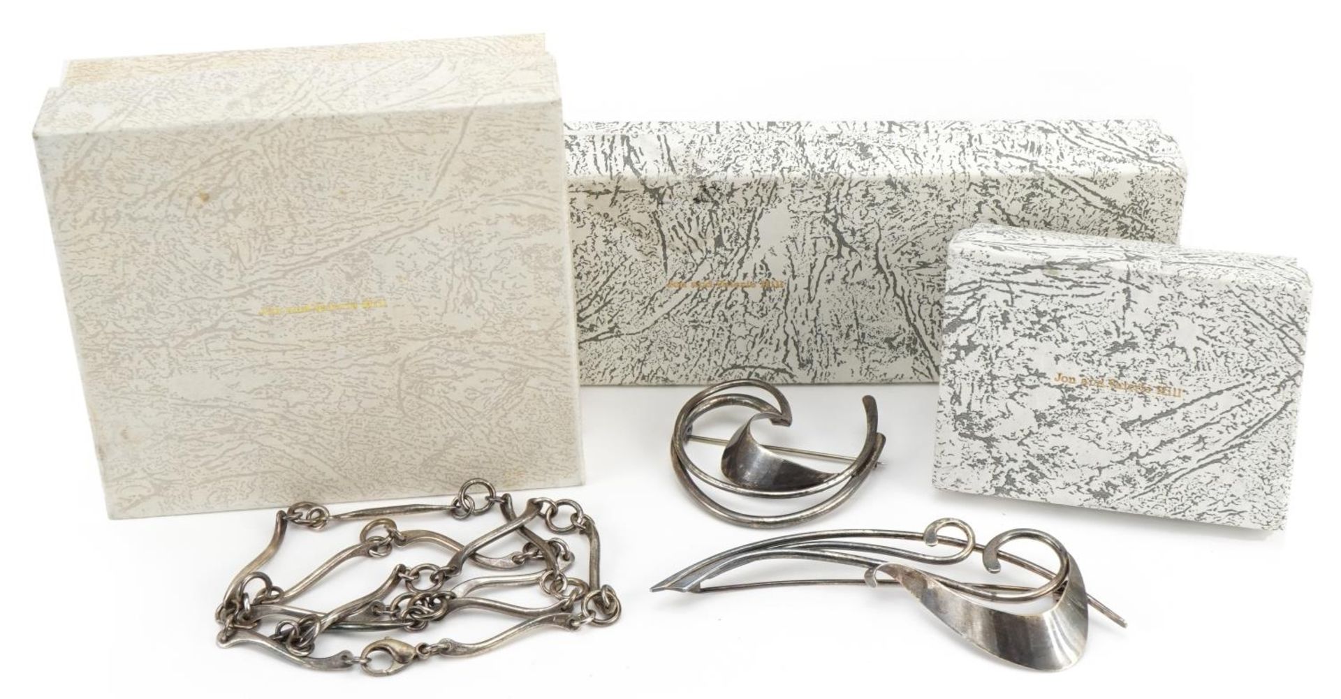 Jon & Valerie Hill, silver jewellery comprising multi link necklace and two brooches, the largest